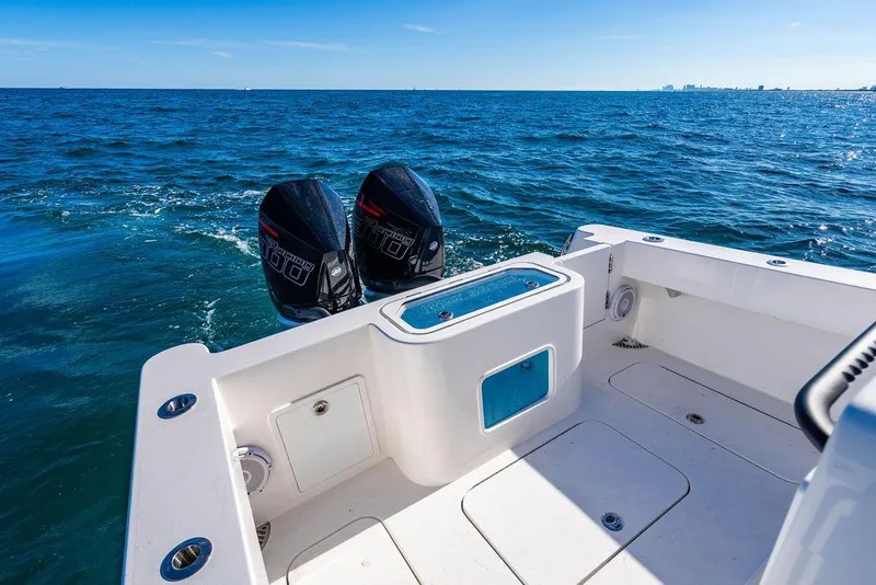 Slide: The Image of 2026 Reef Runner 280 boat with dual engines on open sea. - 14