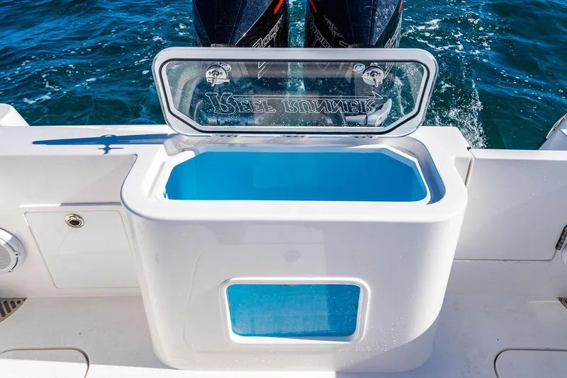Slide: The Image of Livewell on 2026 Reef Runner 280 boat with dual engines in ocean setting. - 15