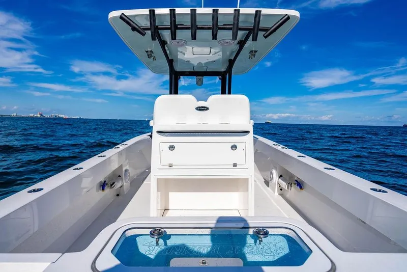 Slide: The Image of 2026 Reef Runner 280 boat on open sea under clear blue sky. - 16