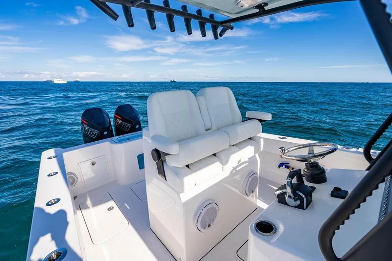 Slide: The Image of 2026 Reef Runner 280 boat interior with dual engines on open sea. - 23
