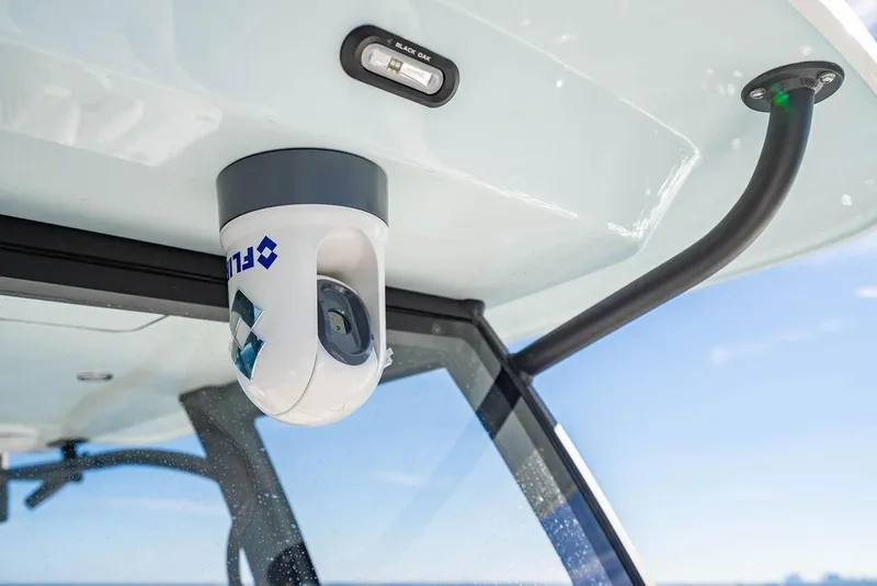 Slide: The Image of FLIR camera mounted on 2026 Reef Runner 280 boat, under clear blue sky. - 27