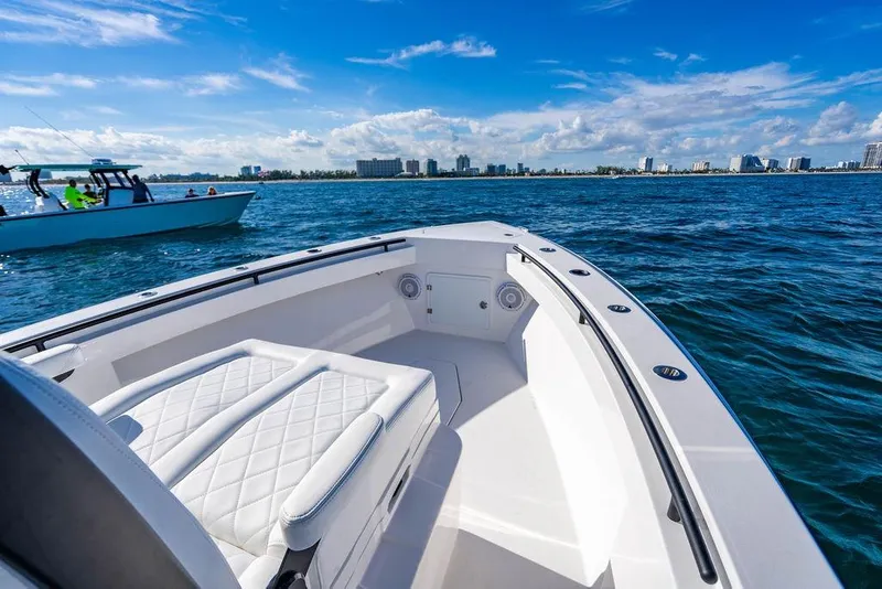 Slide: The Image of 2026 Reef Runner 280 boat on open water, featuring sleek design and comfortable seating. - 28