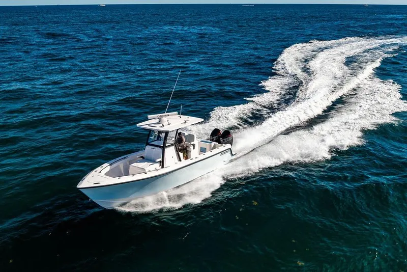 Slide: The Image of 2026 Reef Runner 280 boat cruising on open ocean waters. - 32