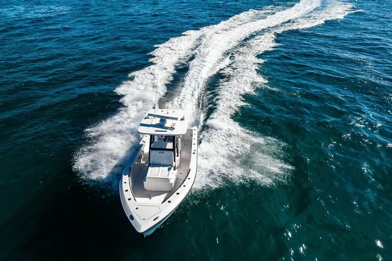 Slide: The Image of 2026 Reef Runner 280 boat cruising on open blue ocean waters. - 33