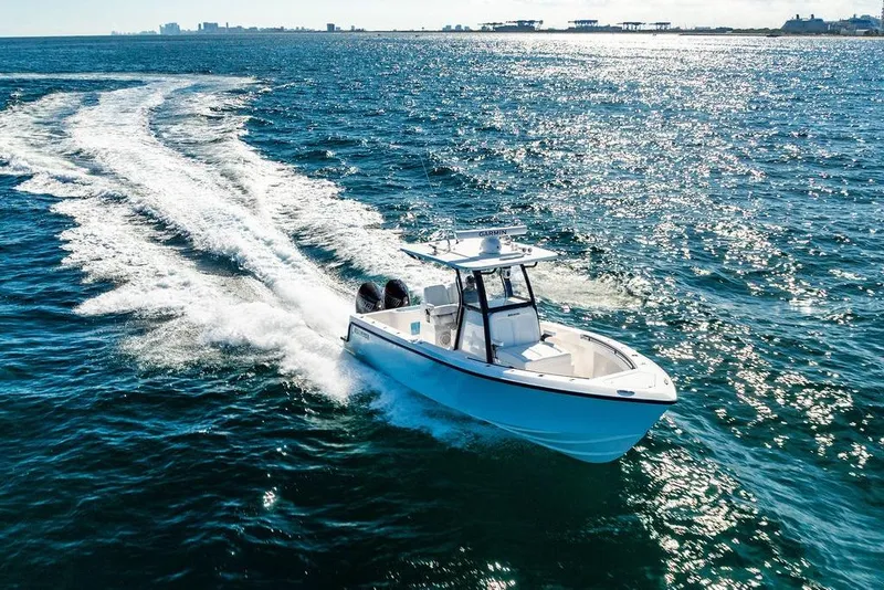 Slide: The Image of 2026 Reef Runner 280 boat cruising on open water under clear skies. - 7