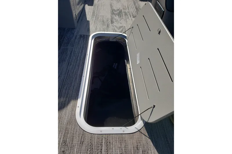 Slide: The Image of Open storage compartment on 2026 Bentley Pontoons Elite 253 Swingback Bench. - 15
