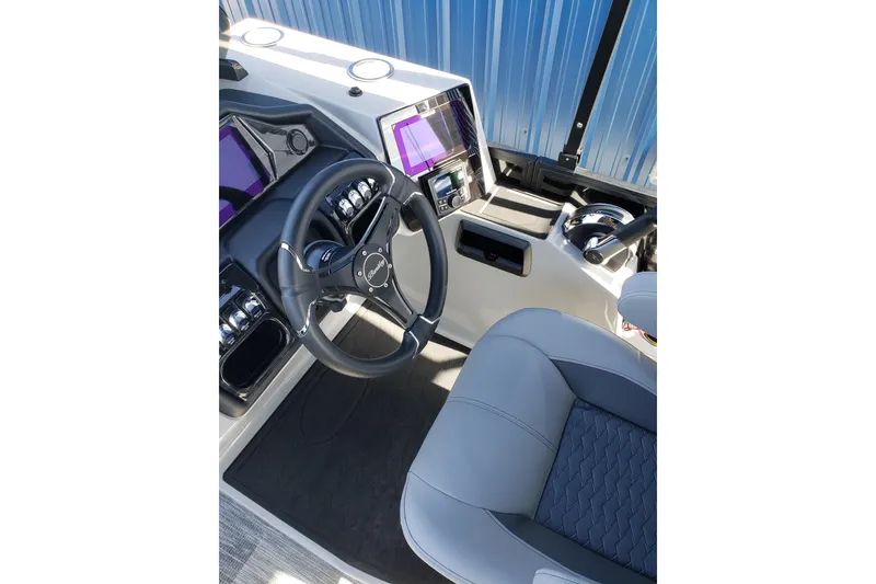Slide: The Image of Interior of 2026 Bentley Pontoons Elite 253 Swingback Bench with steering wheel and controls. - 22