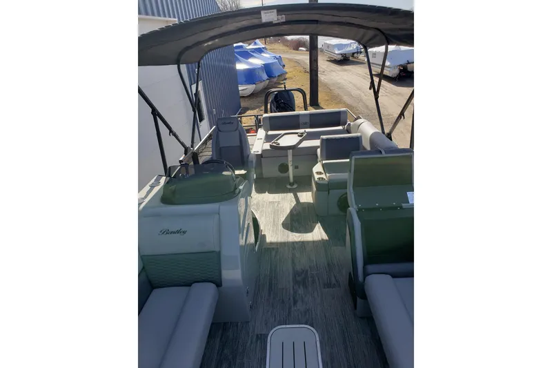 Slide: The Image of 2026 Bentley Pontoons Elite 253 Swingback Bench interior with seating and canopy. - 23