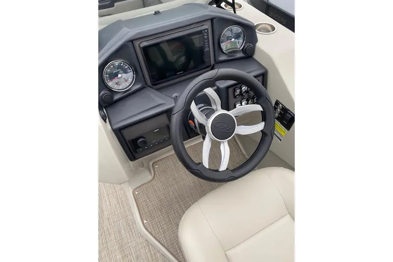 Slide: The Image of 2026 Manitou 25 Encore SL SHP boat dashboard with steering wheel and gauges. - 18