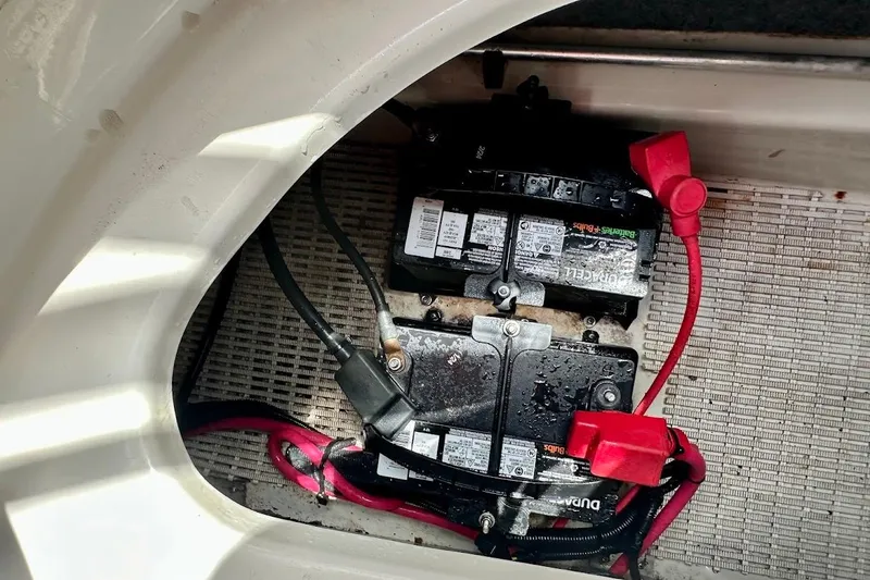 Slide: The Image of Battery compartment of a 2004 Sea Ray 200 Sundeck boat with visible wiring. - 21