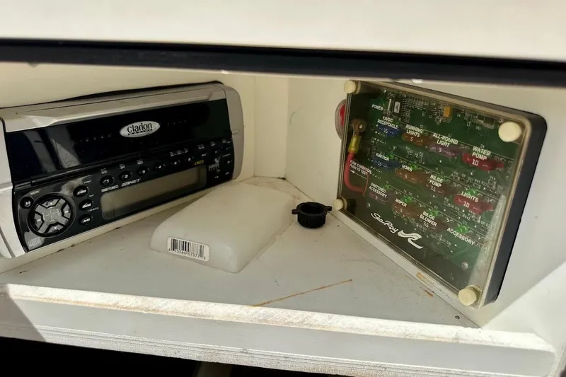 Slide: The Image of 2004 Sea Ray 200 Sundeck stereo and fuse panel in storage compartment. - 9