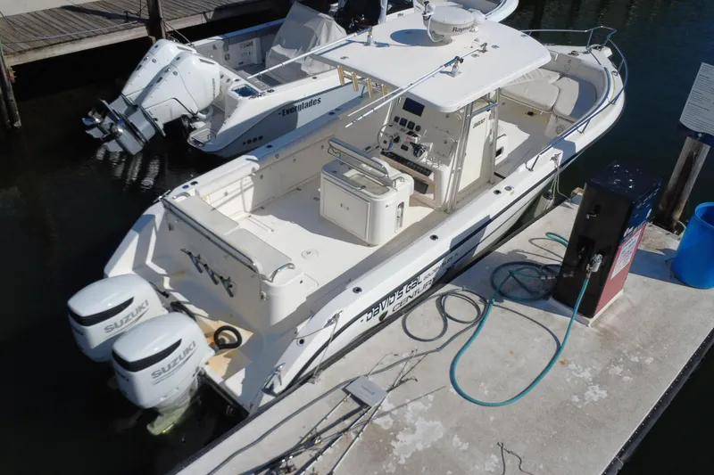 Slide: The Image of 2006 Century 3200 Center Console boat docked with twin Suzuki engines. - 10