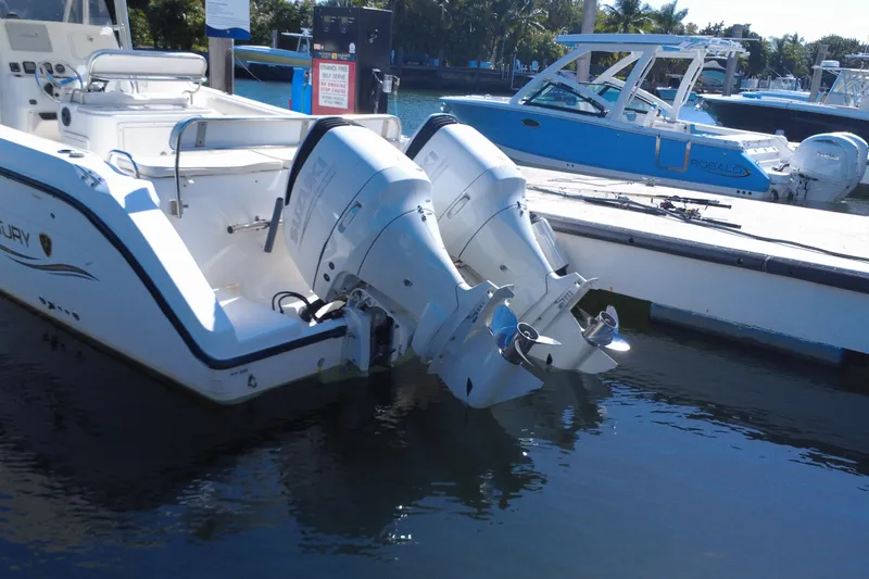 Slide: The Image of 2006 Century 3200 Center Console boat with dual outboard engines docked at marina. - 14