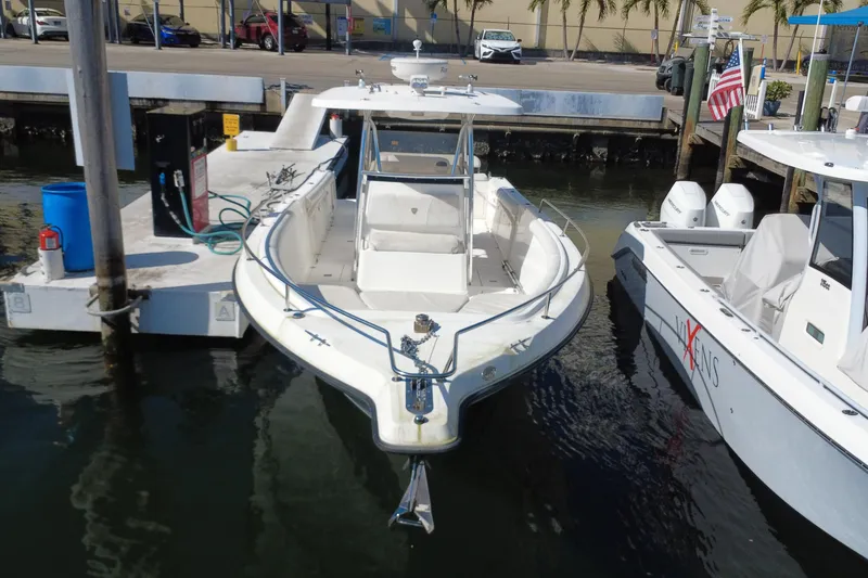 Slide: The Image of 2006 Century 3200 Center Console boat docked at marina with fueling station. - 2