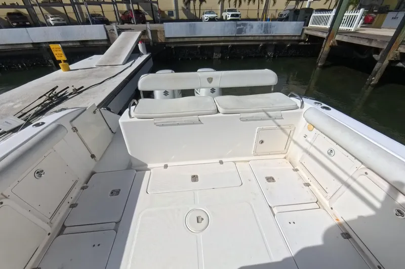 Slide: The Image of 2006 Century 3200 Center Console boat interior at dock, featuring spacious seating and storage. - 20