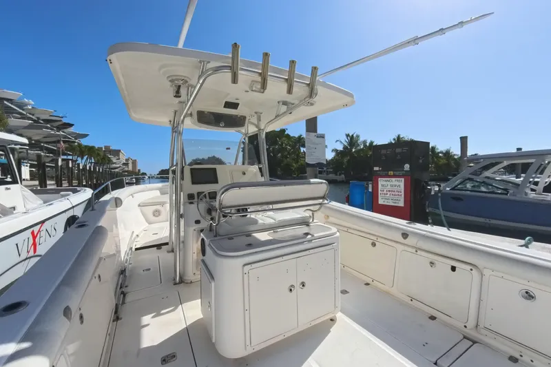 Slide: The Image of 2006 Century 3200 Center Console boat docked, featuring spacious deck and modern controls. - 22