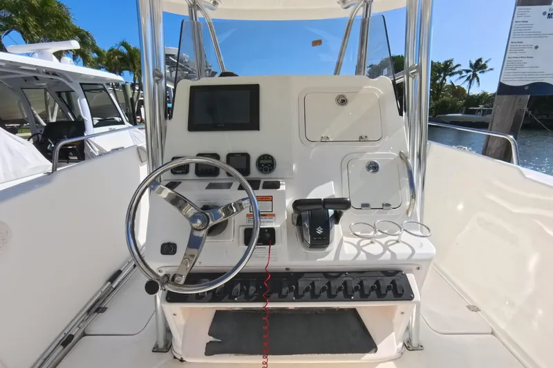 Slide: The Image of 2006 Century 3200 Center Console boat dashboard with steering wheel and controls. - 25