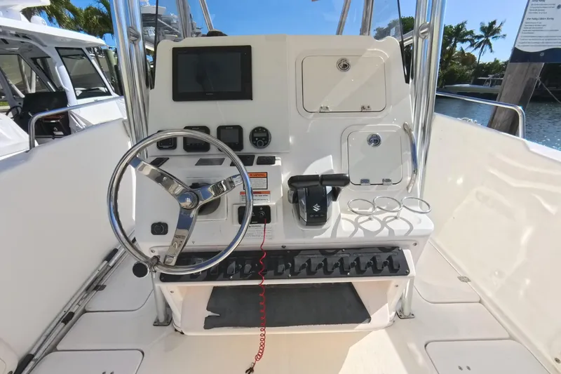Slide: The Image of 2006 Century 3200 Center Console boat dashboard with steering wheel and controls. - 26