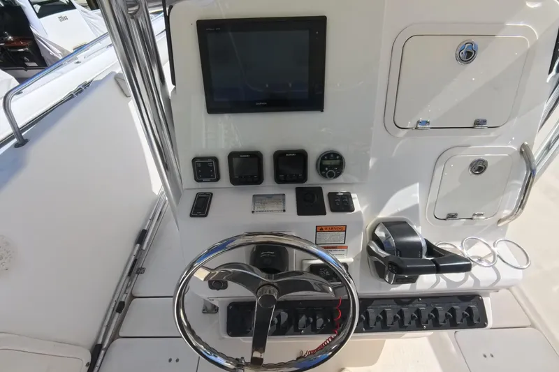 Slide: The Image of 2006 Century 3200 Center Console boat dashboard with steering wheel and control panel. - 27