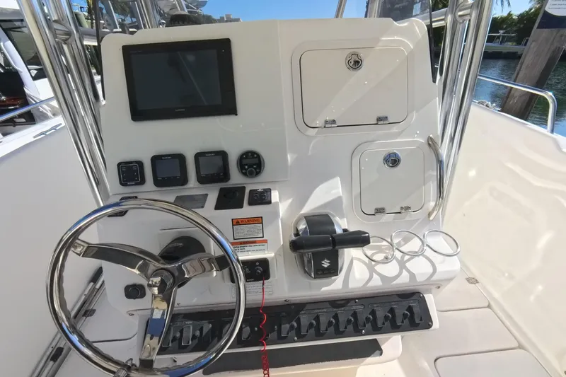 Slide: The Image of 2006 Century 3200 Center Console boat dashboard with steering wheel and control panel. - 28