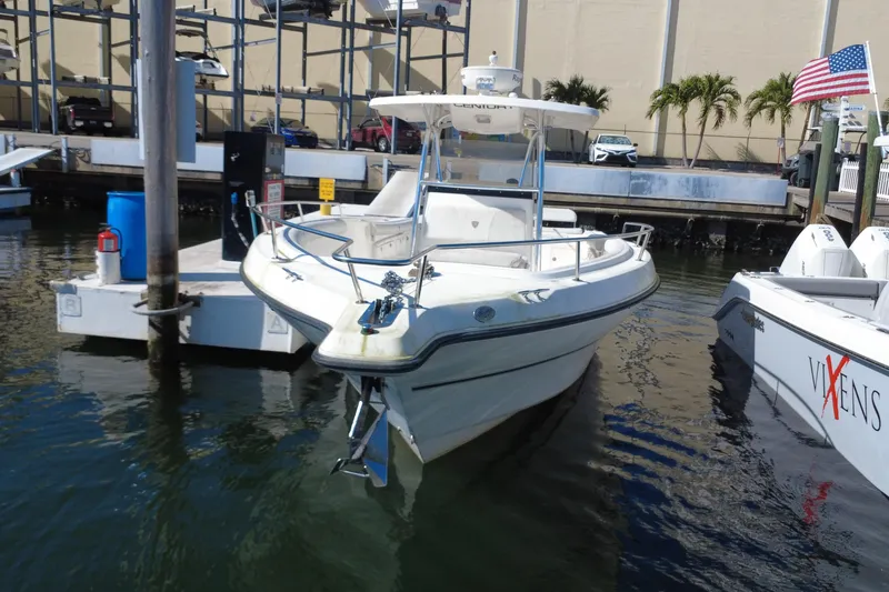 Slide: The Image of 2006 Century 3200 Center Console boat docked at marina with American flag. - 3