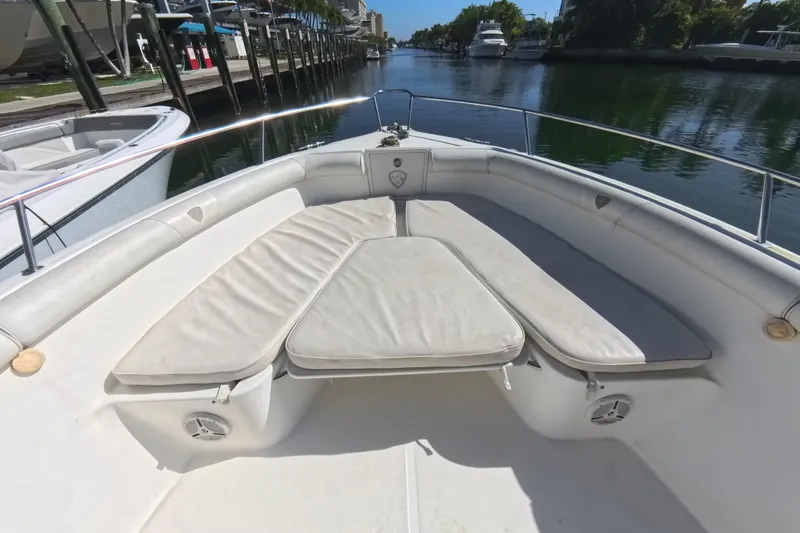 Slide: The Image of 2006 Century 3200 Center Console boat with cushioned seating, docked by a serene waterway. - 30