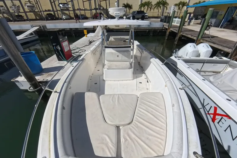 Slide: The Image of 2006 Century 3200 Center Console boat docked at marina, featuring spacious seating and dual engines. - 32