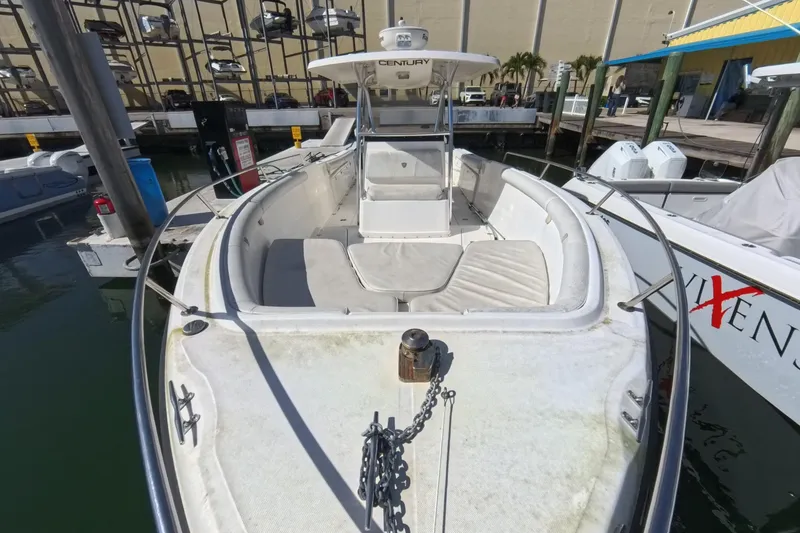 Slide: The Image of 2006 Century 3200 Center Console boat docked at marina, featuring spacious seating and helm. - 33