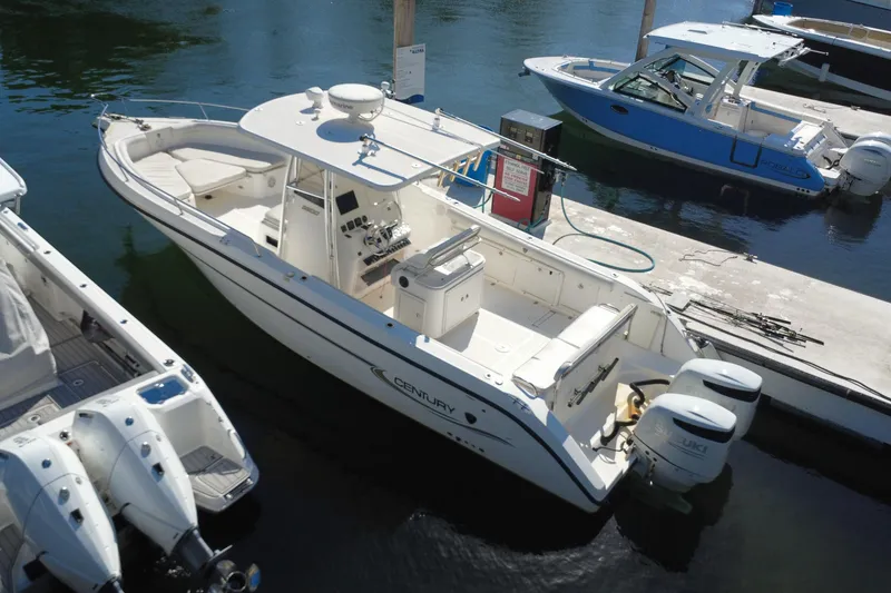 Slide: The Image of 2006 Century 3200 Center Console boat docked with twin Suzuki engines. - 5