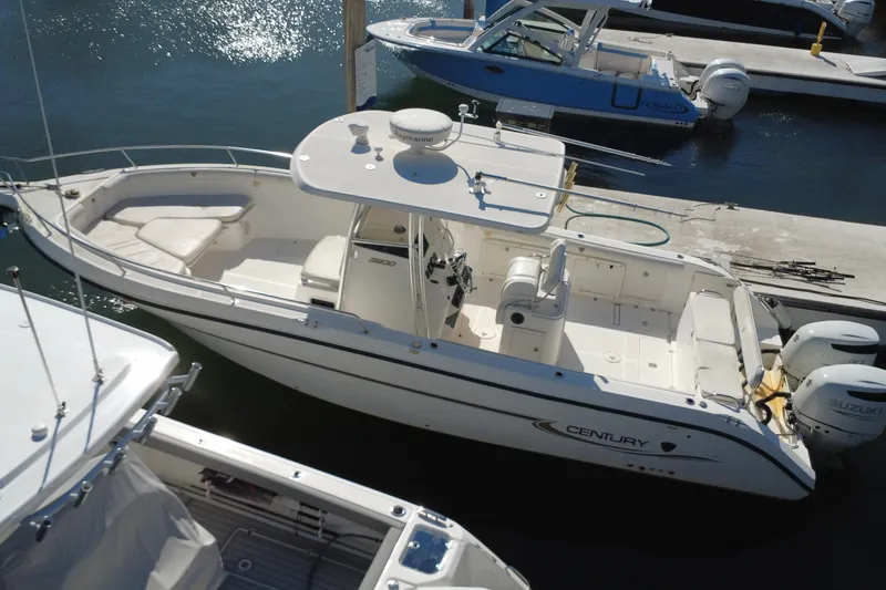 Slide: The Image of 2006 Century 3200 Center Console boat docked at marina with twin Suzuki engines. - 6