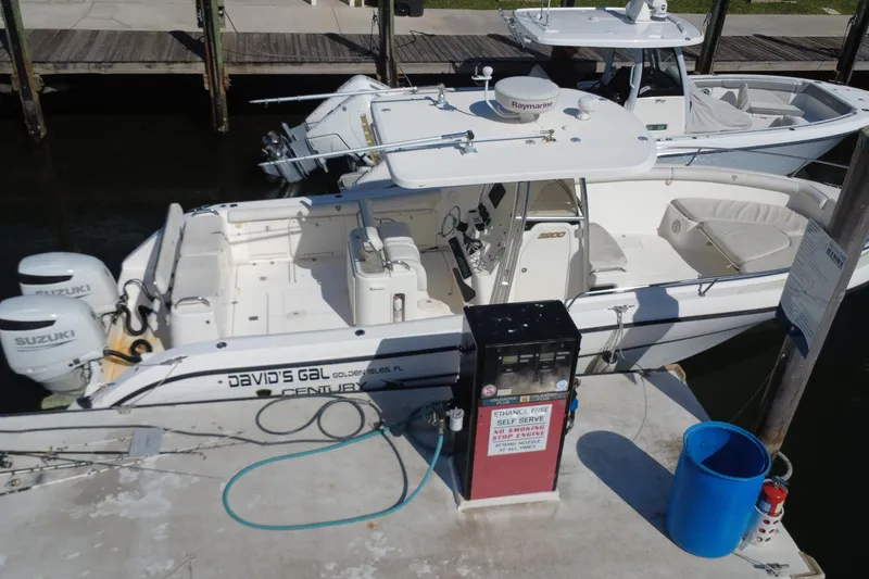 Slide: The Image of 2006 Century 3200 Center Console boat docked at marina with fuel pump. - 9