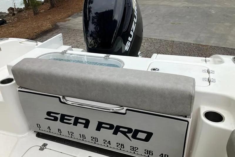 Slide: The Image of 2022 Sea Pro 239 Deep V CC boat with Suzuki engine, featuring cushioned seating. - 10