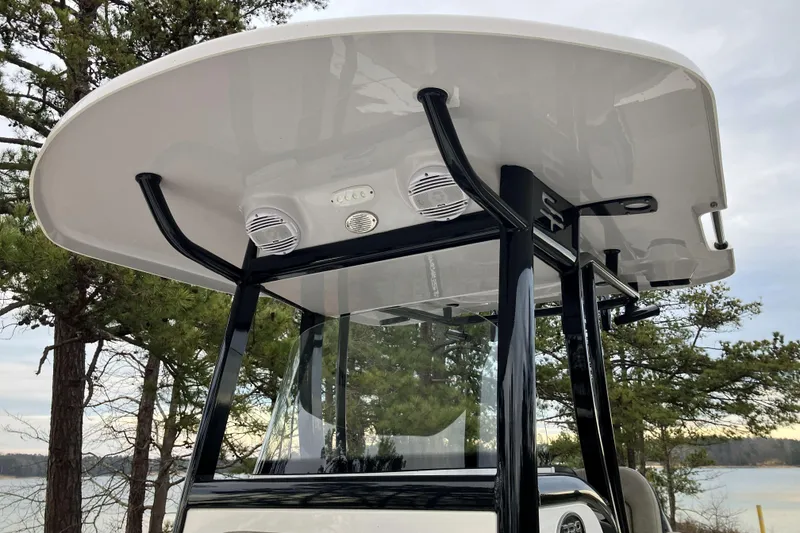 Slide: The Image of 2022 Sea Pro 239 Deep V CC boat with T-top and speakers, set against a scenic backdrop. - 12