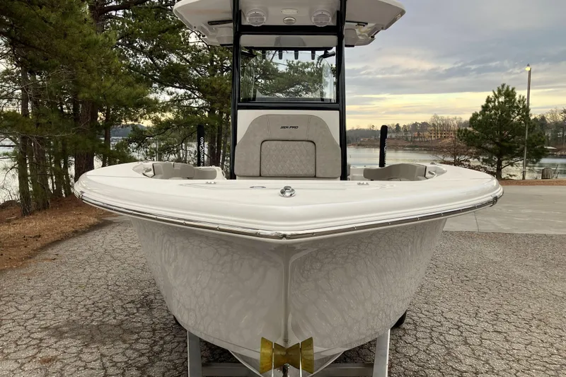 Slide: The Image of 2022 Sea Pro 239 Deep V CC boat on a lakeside driveway with trees. - 3