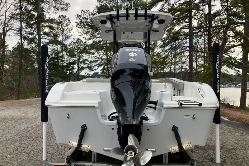 Slide: The Image of 2022 Sea Pro 239 Deep V CC boat with powerful outboard motor, parked near a scenic lake. - 7
