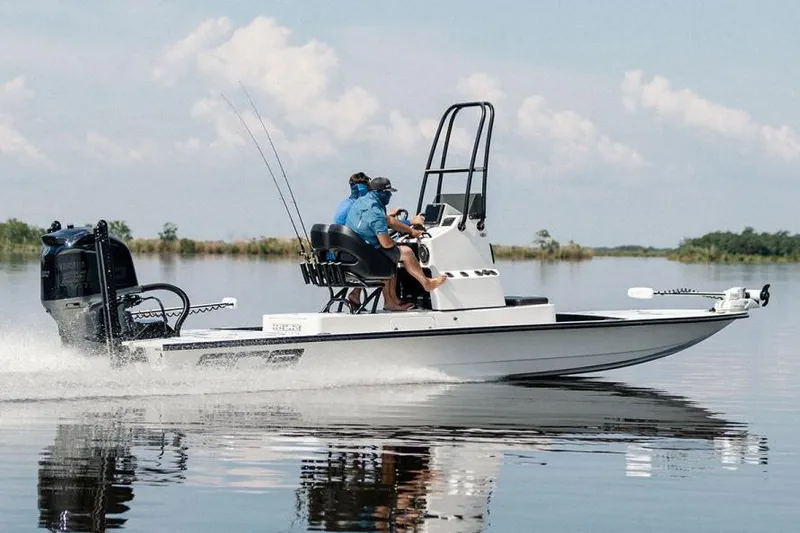 Slide: The Image of Manufacturer Provided Image: 2026 SCB R24 boat speeding on calm water with two passengers. - 1