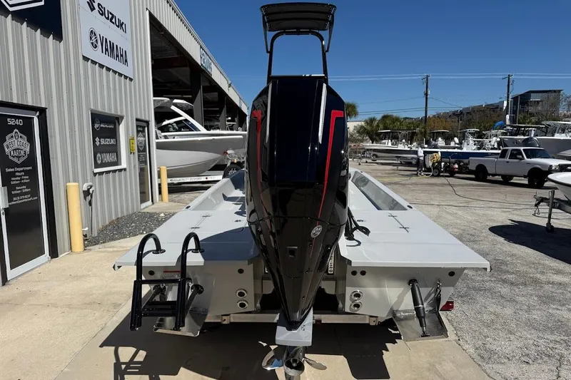 Slide: The Image of 2026 SCB R24 boat with powerful outboard motor at a marine dealership. - 11