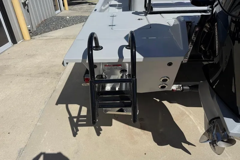 Slide: The Image of Rear view of 2026 SCB R24 boat with ladder and motor. - 12