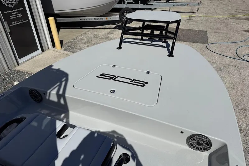 Slide: The Image of 2026 SCB R24 boat deck with logo, docked near service department. - 18