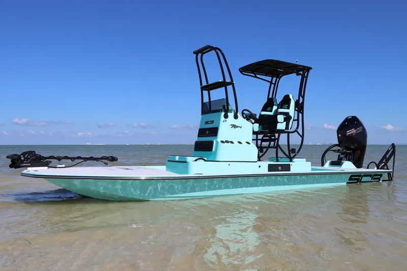 Slide: The Image of Manufacturer Provided Image: 2026 SCB R24 boat in turquoise on calm water under clear blue sky. - 4
