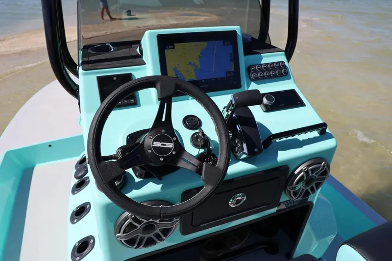 Slide: The Image of Manufacturer Provided Image: 2026 SCB R24 boat dashboard with steering wheel and navigation display. - 7