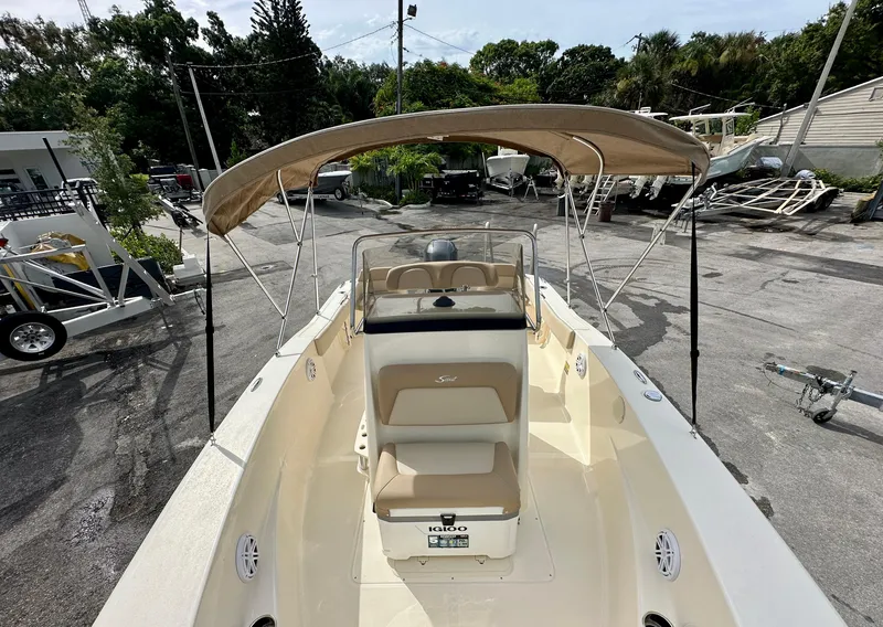 Slide: The Image of Scout 195 Sportfish 2025 with canopy parked outdoors. - 10