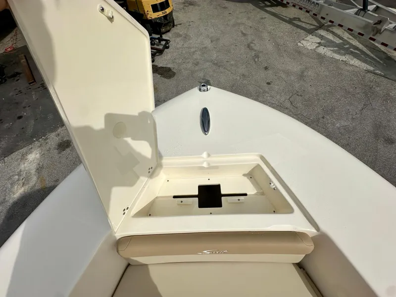 Slide: The Image of Scout 195 Sportfish 2025 with open storage compartment lid. - 11