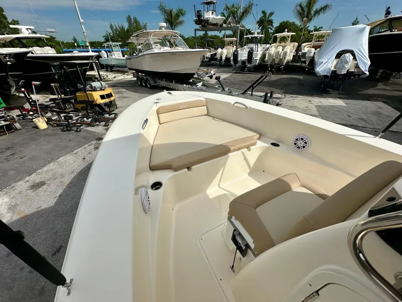 Slide: The Image of Scout 195 Sportfish 2025 at marina, interior view with seating area. - 8