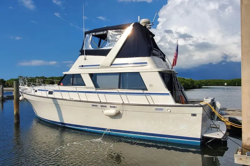 The Image of 1988 Mainship 36 Nantucket Sedan yacht docked on a sunny day. - 0