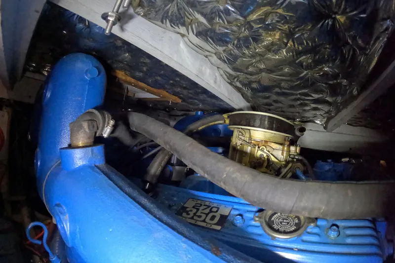 Slide: The Image of 1988 Mainship engine compartment with blue components and visible hoses. - 111