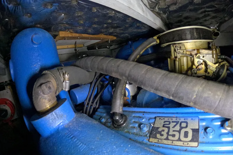 Slide: The Image of 1988 Mainship engine compartment with blue components and Model 270 350 CID label. - 114