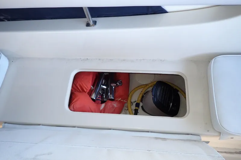 Slide: The Image of Storage compartment on a 1988 Mainship boat with life jacket and equipment. - 42