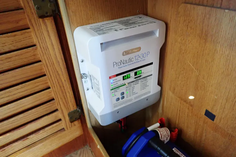 Slide: The Image of ProNautic 12-30P battery charger installed in 1988 Mainship boat's wooden cabinet. - 49