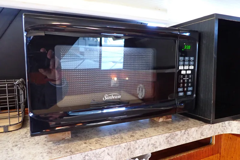 Slide: The Image of Sunbeam microwave on a Mainship boat, 1988 model, with digital display and control panel. - 62